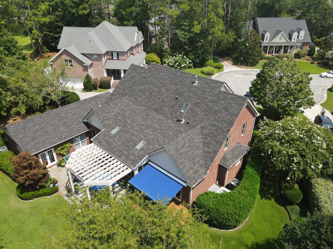 Aerial view of a residential neighborhood featuring well-maintained homes and gardens.